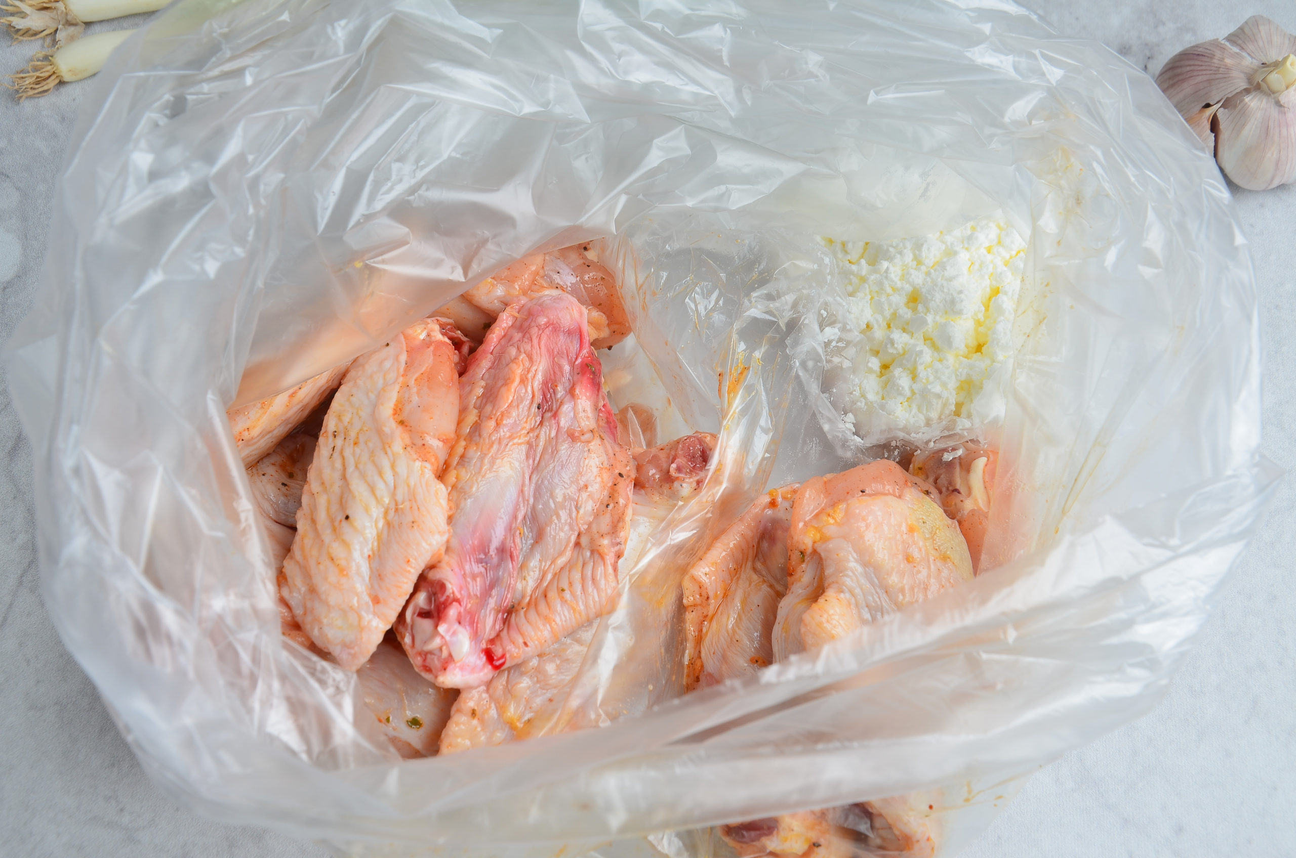 Marinated wings with starch in a plastic bag